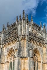 Fototapeta na wymiar Detail view of the ornate Gothic exterior facade of the Monastery of Batalha, Mosteiro da Batalha, literally the Monastery of the Battle, is a Dominican convent, in Leiria, Portugal