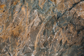 Natural background or texture. Orange and ocher natural mute colours. Abstract stone mica background. Close up.