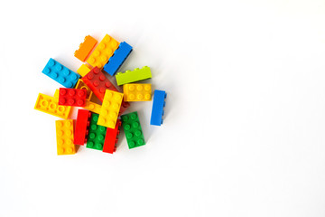 Multicolor Plastick constructor bricks on white background. Popular toys. Copyspace