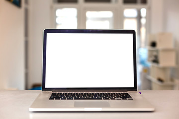 Fototapeta premium Close up Laptop Computer on Top of Office Table of a Businessman with Empty White Screen, Emphasizing Copy Space.