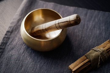 Bronze tibetan singing bowl with wooden stick, palo santo wood. Sound healing, sound bath therapy