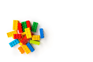 Bunch of Colorful Plastick constructor cubes on white background. Popular toys. Copyspace