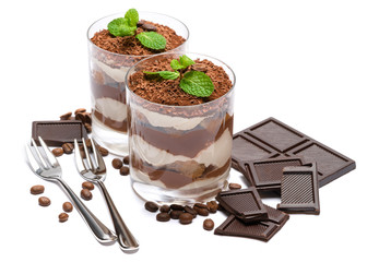 two portions Classic tiramisu dessert in a glass and chocolate bar isolated on a white background