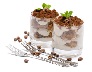 two portions Classic tiramisu dessert in a glass isolated on a white background