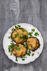 stuffed mushrooms with cheese and herbs on white beautiful dish