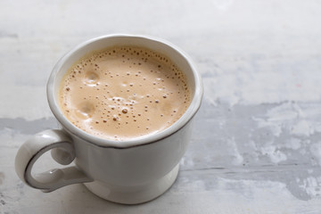 a cup of coffee on ceramic background