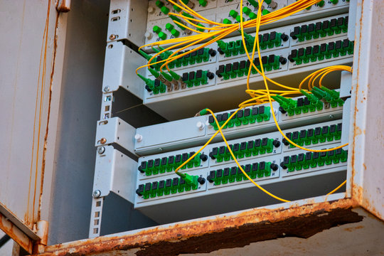 Open box with patch-panels with many fiber optic cords