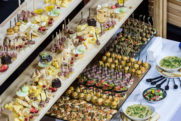 Mini canape with cheese meat and seafood close-up shot.