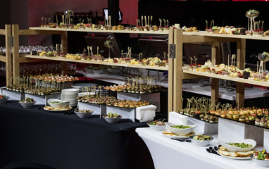 Banquet buffet with snacks delicacies cheese canapes desserts.