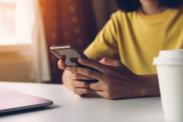woman holding smartphone,  using cell phone on cafe. Technology for communication concept.