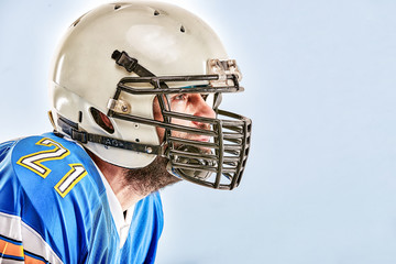 American football player posing on white background