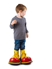 Young boy with big clown shoes