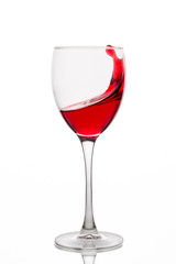 Red wine splash in a glass isolated on white background