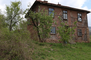 Fototapeta na wymiar Old ruined house adobe and wood facade in village Gara Bov, Bulgaria. Old adobe wall. Brown, detail.