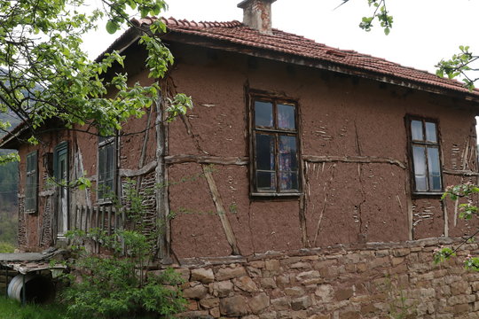 Old ruined house adobe and wood facade in village Gara Bov, Bulgaria. Old adobe wall. Brown, detail.