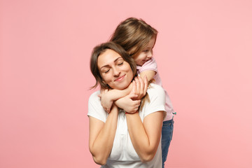 Woman in light clothes have fun with cute child baby girl. Mother, little kid daughter isolated on...