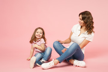Obraz na płótnie Canvas Woman in light clothes have fun with cute child baby girl. Mother, little kid daughter isolated on pastel pink wall background, studio portrait. Mother's Day, love family, parenthood childhood concept