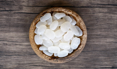 Sugar palm fruit on wooden plate on wood background.