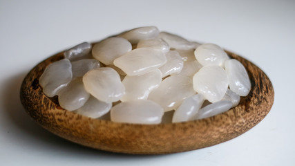 Sugar palm fruit on wooden plate on white background.
