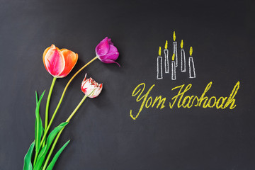 Six candles and inscription on chalkboard Yom HaShoah - Holocaust and Heroism Remembrance Day