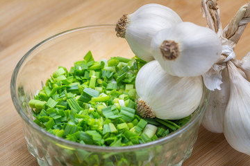 Chopped green garlic on cutting board preparated for cooking.