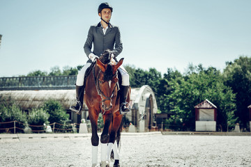 Nice young man having a ride on the horse