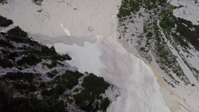 Aerial view of the mudflow with snow high in the Alpine mountains