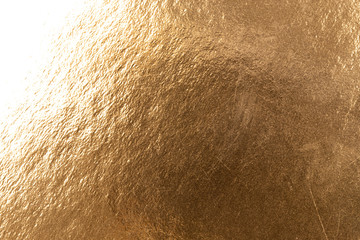 Abstract texture of golden metal macro shot background at close range