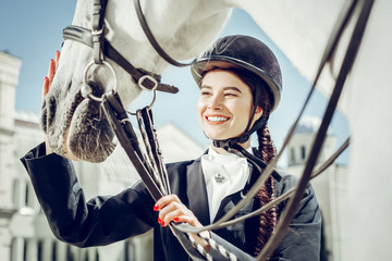 Joyful pretty woman looking at her horse © Viacheslav Yakobchuk