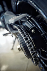 View of the back of a motorcycle with an emphasis on the chain.