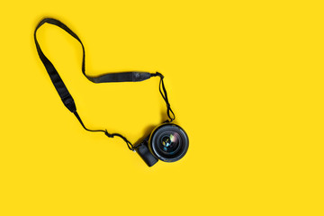 Mirrorless black camera on yellow background, summer memmories photograher blog - Powered by Adobe