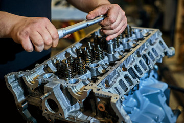 Automotive four-cylinder engine water cooling during repair.