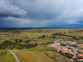 Aerial view of a farm field with storm clouds in background. Alentejo Portugal