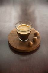 A cup of coffee with macadamia nut.