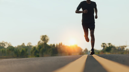 Athlete runner feet running on road, Jogging concept at outdoors. Man running for exercise.