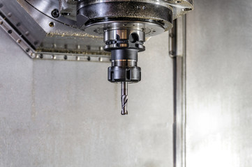 Drill in the collet on the CNC machine, close-up engineering production.