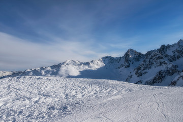 Fototapeta na wymiar Winter panorama of mountains in Pitztal Hoch Zeiger ski resort in Austria Alps. Ski slopes. Beautiful winter day.