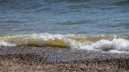 Fototapeta na wymiar Ocean waves onto pebble beach