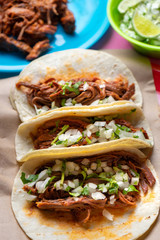 Mexican beef barbacoa tacos on colorful background