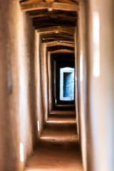 Obraz premium Fortress stone tunnel path passage view in Castiglione del Lago in Italy during summer with windows and shadows contrast in historic town village fort