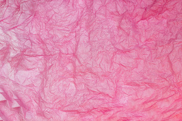 Pink wrinkled paper texture background. Crumpled sheet of paper