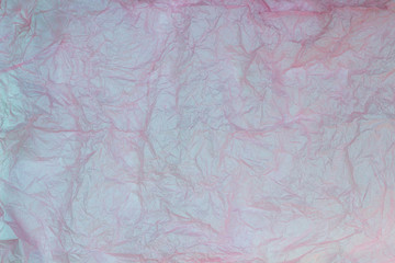 Pink wrinkled paper texture background. Crumpled sheet of paper