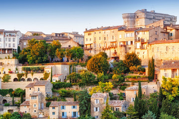 Naklejka premium French famous landmark in Provence - old town Gordes. Amazing sunset view on panorama. Iconic travel destination spot in France, Provence - medieval city Gordes in Luberon area. 