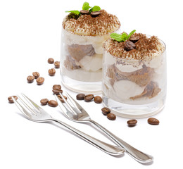 two portions Classic tiramisu dessert in a glass isolated on a white background
