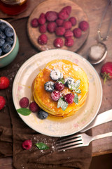 Stack of pancakes with fresh berries, close-up.