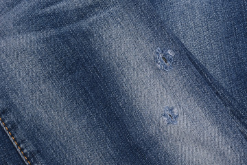 Naklejka premium The surface of the jeans with torn marks, Texture Blue jean.