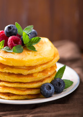 Stack of pancakes with fresh berries, close-up.