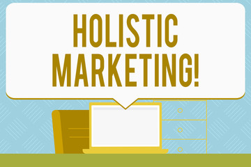 Writing note showing Holistic Marketing. Business concept for developed by thinking about the business as a whole Speech Bubble Pointing White Laptop Screen in Workspace Idea
