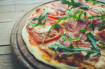 Italian pizza with prosciutto and arugula