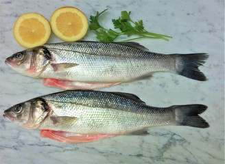 fresh fish with lemon and spices on marble